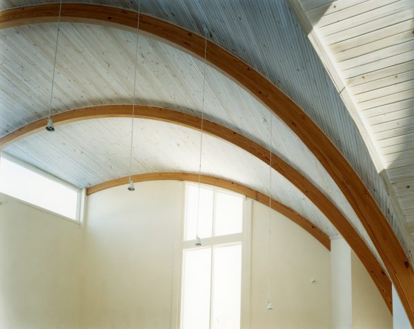 A detail of the curved wooden trusses